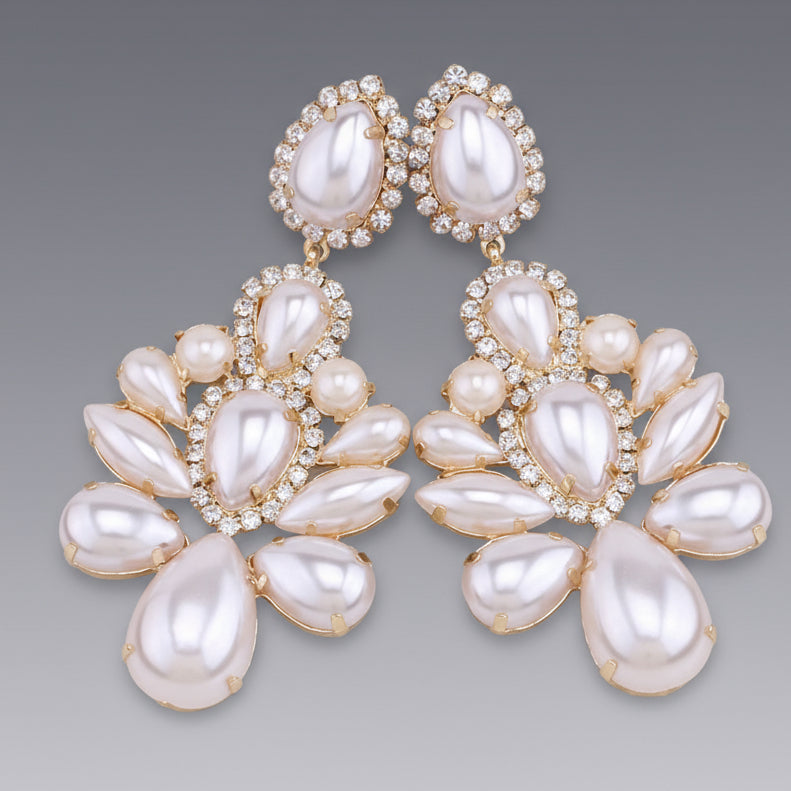 rhinestone and Pearl earrings with gold accents on a gray background