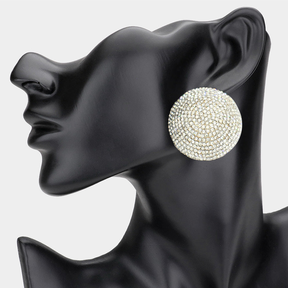 A clip-on evening earring featuring a round, rhinestone pave design, displayed on a black mannequin head.