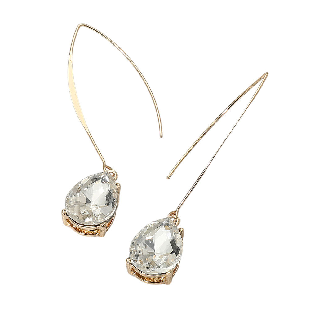 Pair of gold earrings with clear gemstones on a white background
