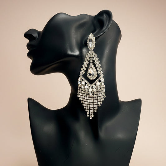 Diamond gold fringe earring on a black mannequin bust against a beige background