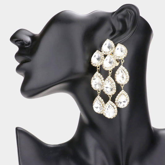 A clip-on earrings featuring a teardrop-shaped stone link dangle, displayed on a black mannequin head.