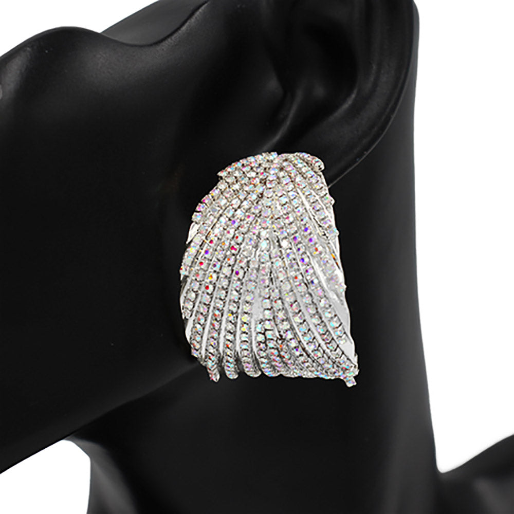 Elegant silver earrings with crystal details on a black mannequin