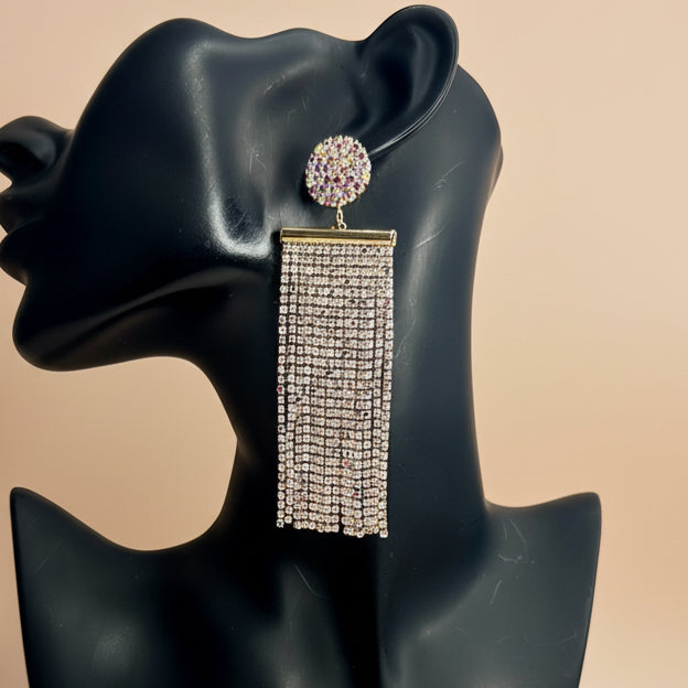 Earring on a black mannequin bust with a beige background