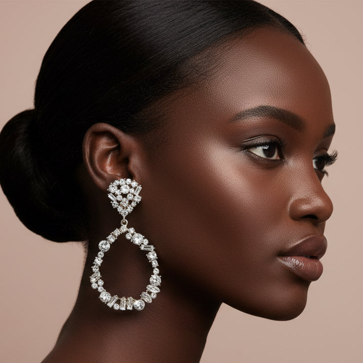 Woman wearing a sparkling earring against a neutral background