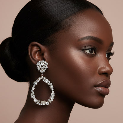 Woman wearing a sparkling earring against a neutral background