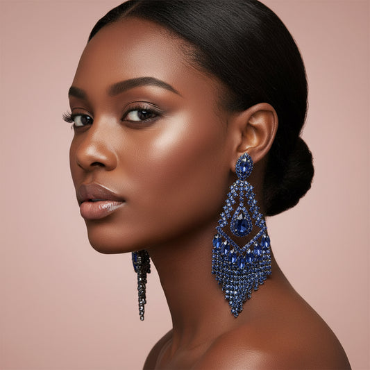 woman wearing Elegant blue crystal earring against a blush background