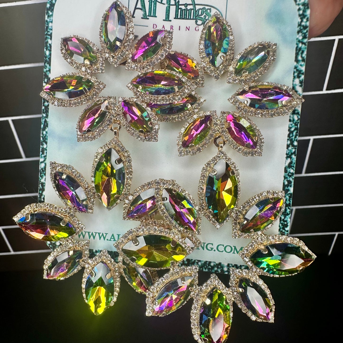 Multicolored gemstone earrings on a card with 'All  Things Daring branding.