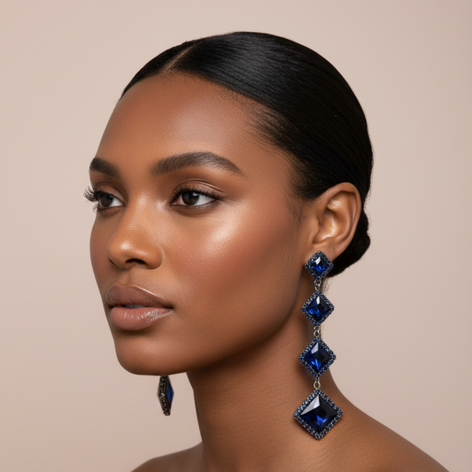 Woman wearing blue gemstone earrings against a beige background